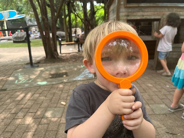 child with magnifying glass